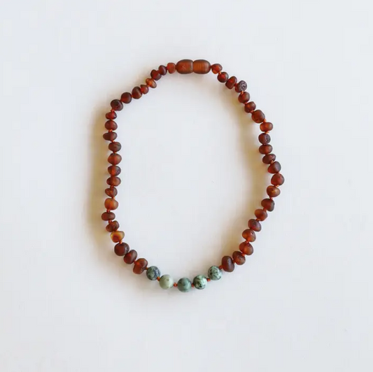 This Raw Cognac Baltic Amber + Turquoise Jasper Beaded Necklace by CanyonLeaf is handmade using original Baltic Sea Amber that is over 45 million years old. Baltic Amber has some of the highest concentrations of Succinic Acid found in nature and this is what makes it so special. Fossilized tree sap that has been preserved for millions of years under the sea. It is a true gift from Mother Nature.&nbsp;